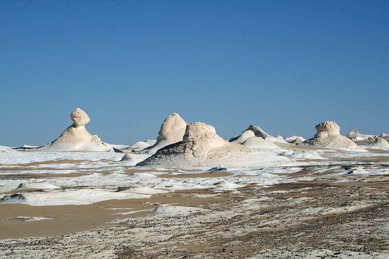 White chalk formations beneath a blue sky in Egypt’s White Desert.